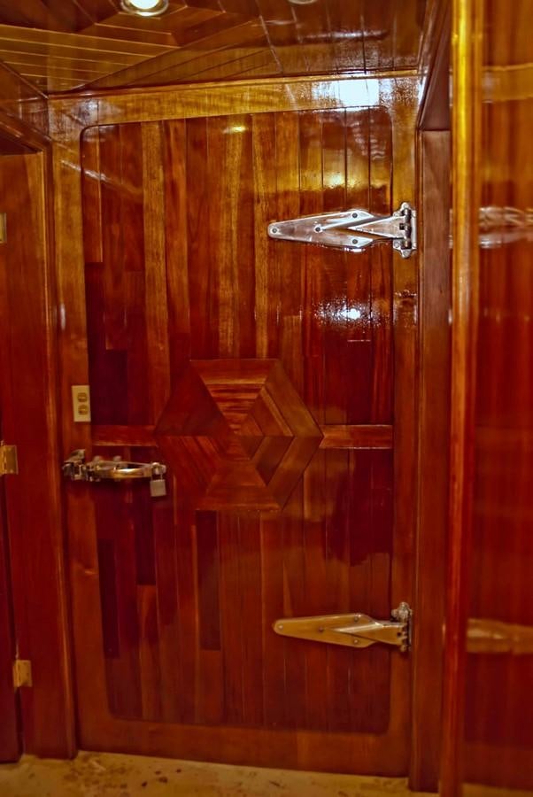 a red door with a metal frame aboard PRINCIPE DEL MAR Yacht for Sale