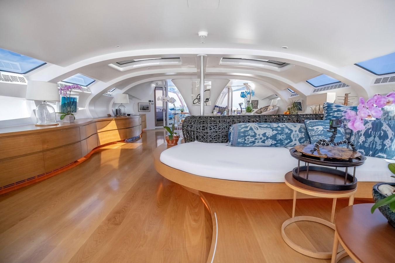 a room with a large bed and a table with chairs aboard ADASTRA Yacht for Sale