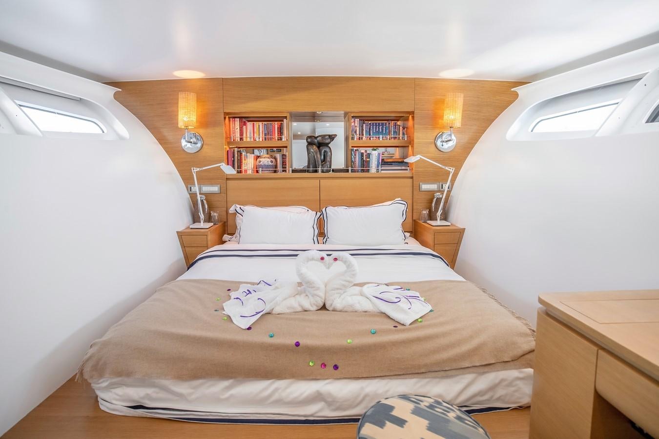 a bed with a white comforter and pillows aboard ADASTRA Yacht for Sale