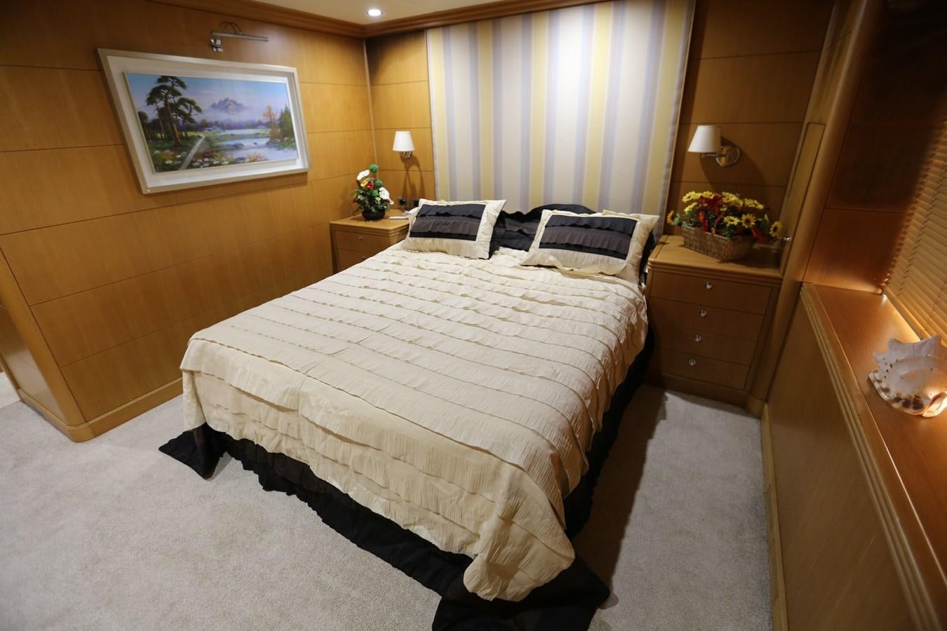a bedroom with a bed and a dresser aboard GOODWILL Yacht for Sale