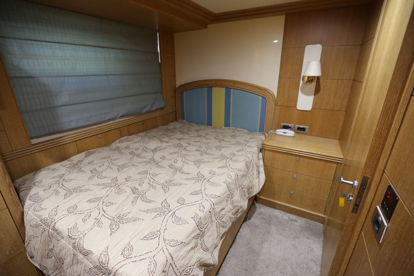 a bedroom with a bed and a window aboard GOODWILL Yacht for Sale