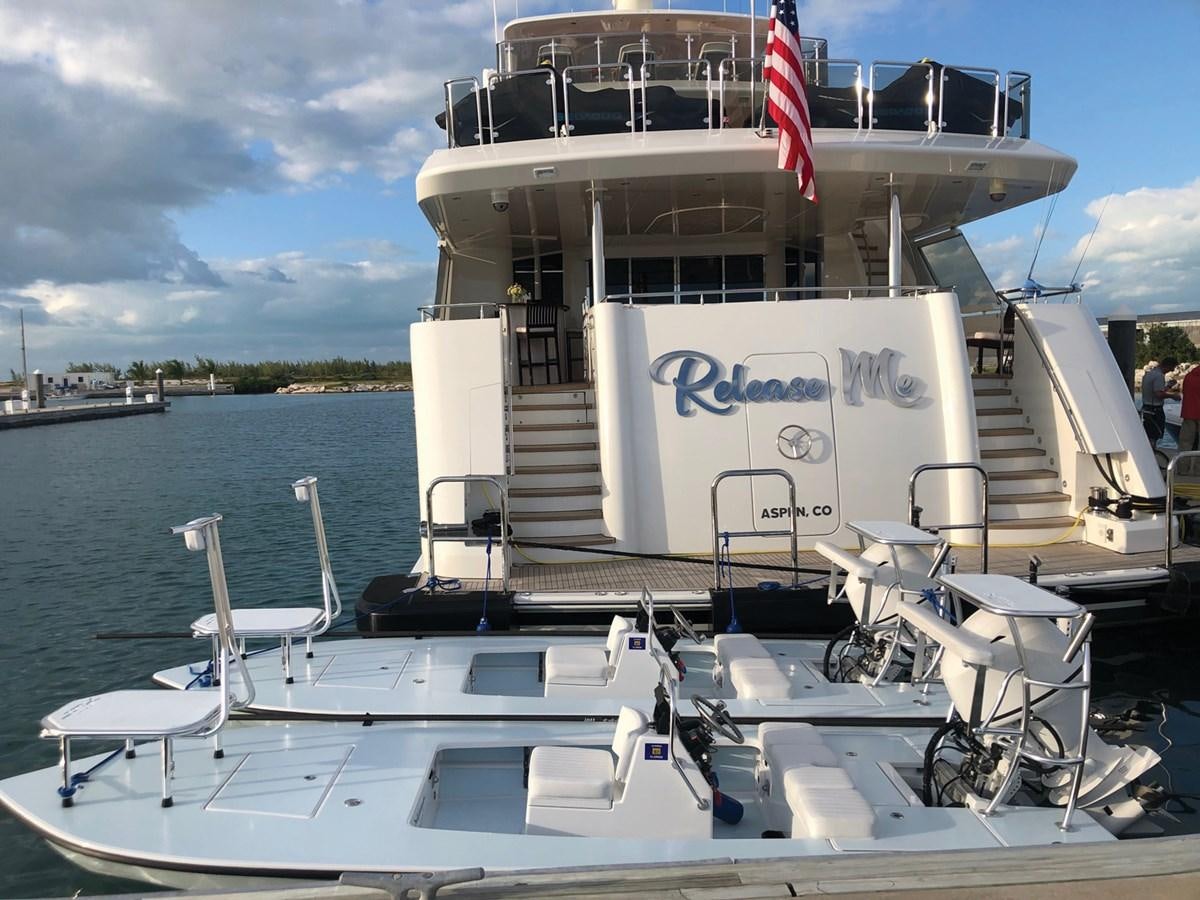 a boat with a flag on the front aboard RELEASE ME Yacht for Sale