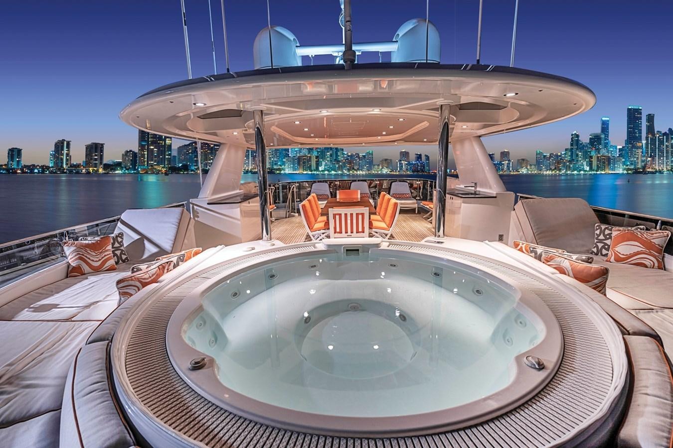 a round white table with a round white table and a large white umbrella on a boat with a aboard RELEASE ME Yacht for Sale