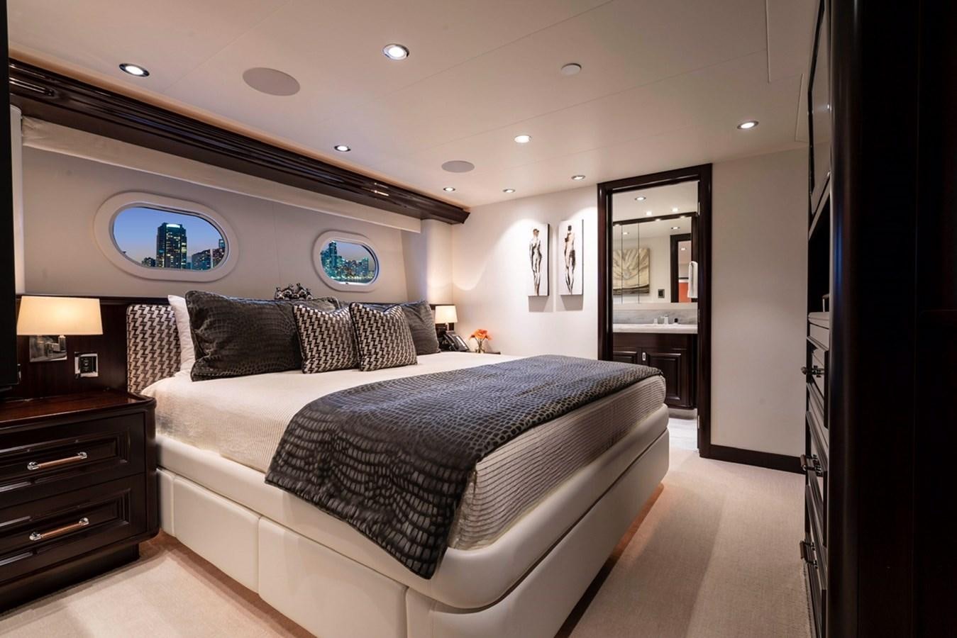 a bedroom with a bed and a dresser aboard RELEASE ME Yacht for Sale