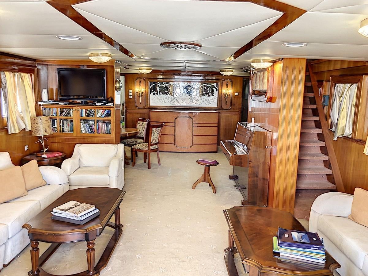a living room with a staircase aboard ELIKI Yacht for Sale