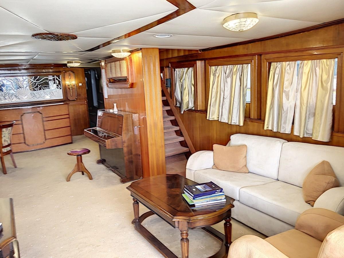 a living room with a staircase and furniture aboard ELIKI Yacht for Sale