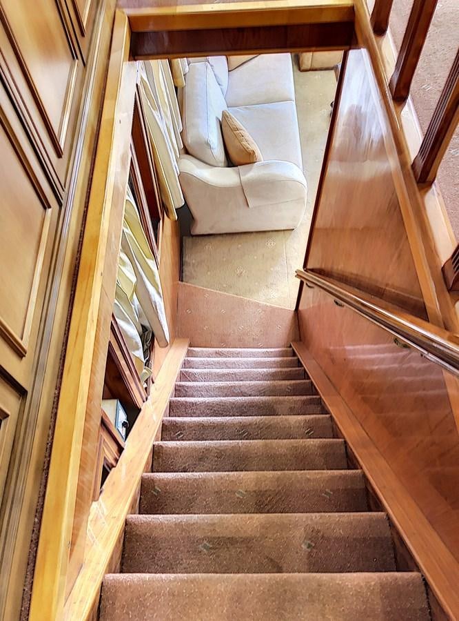 a set of stairs leading up to a couch aboard ELIKI Yacht for Sale