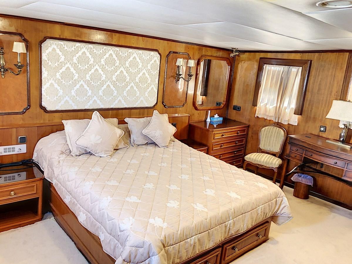a bed with white sheets aboard ELIKI Yacht for Sale