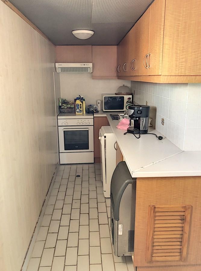 a kitchen with white tiles aboard ELIKI Yacht for Sale