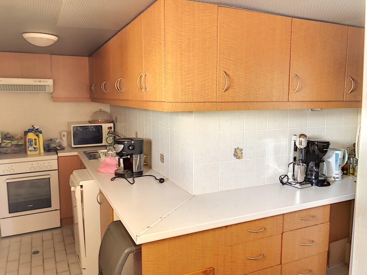 a kitchen with wooden cabinets aboard ELIKI Yacht for Sale