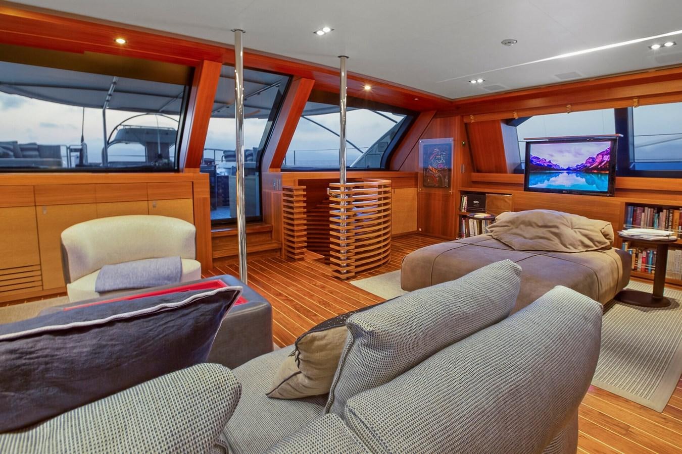a room with couches and a tv aboard STATE OF GRACE Yacht for Sale