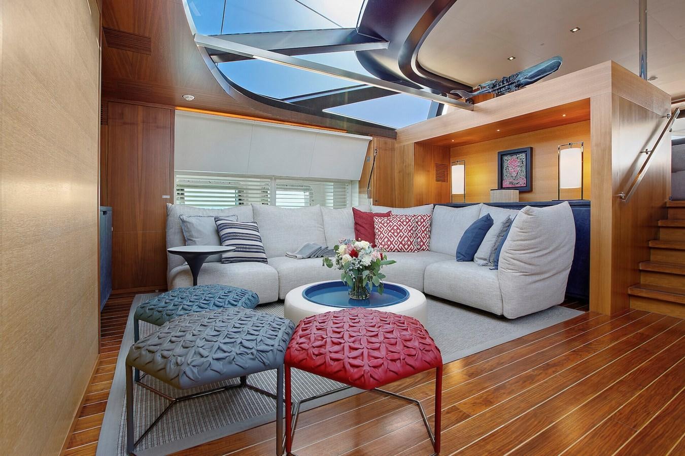 a living room with a couch and a table aboard STATE OF GRACE Yacht for Sale