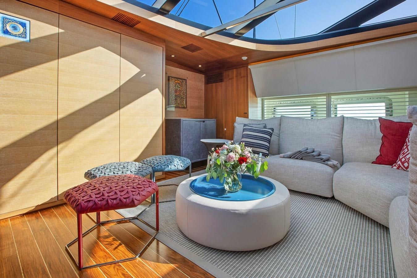 a living room with a couch and a table aboard STATE OF GRACE Yacht for Sale