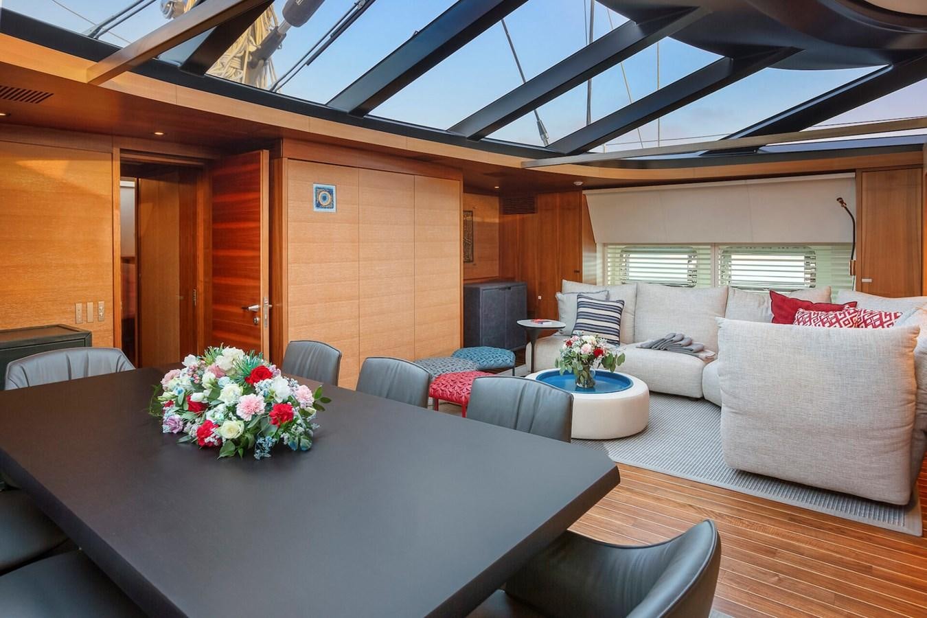 a room with a table and couches aboard STATE OF GRACE Yacht for Sale