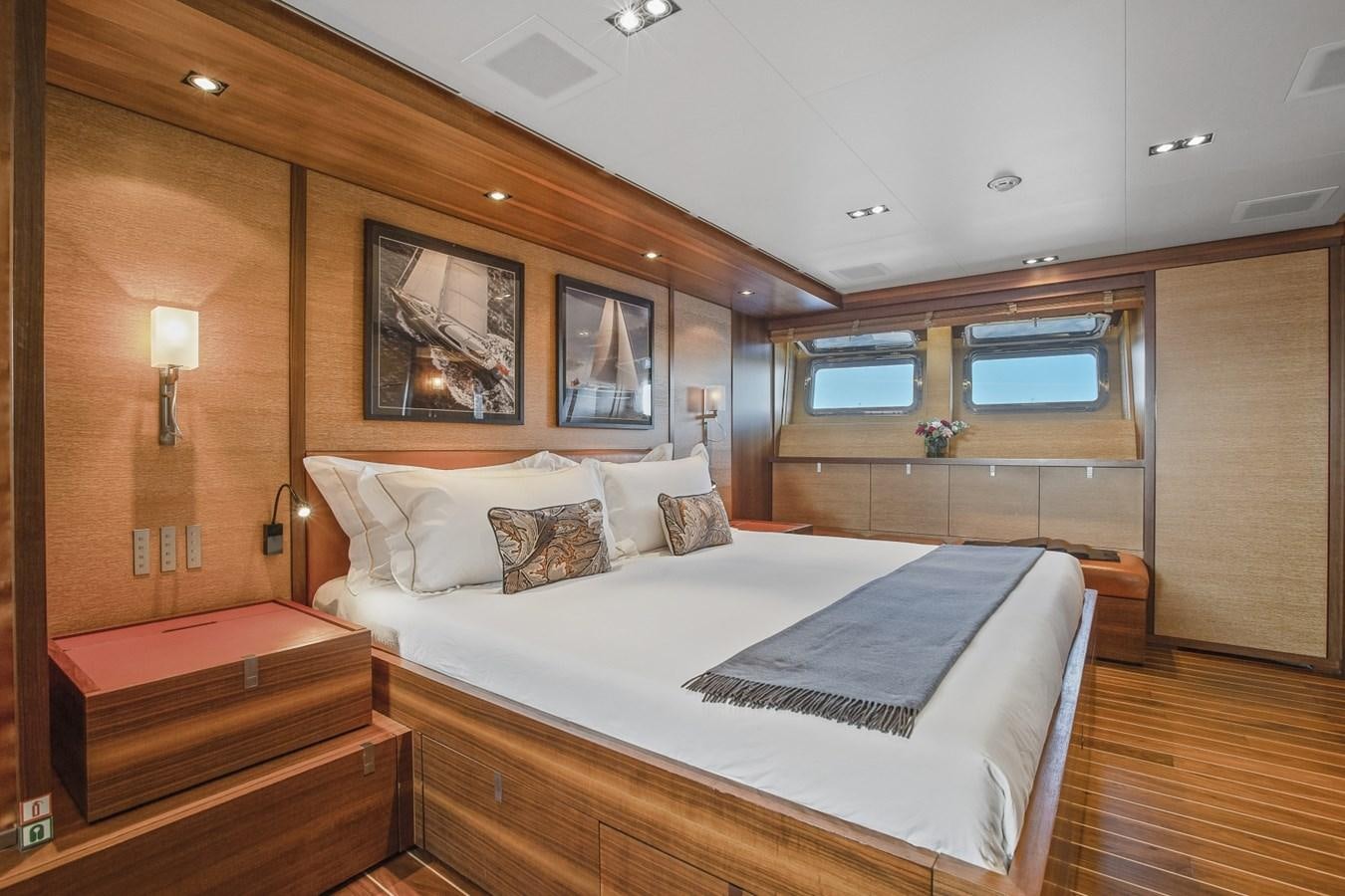 a bedroom with a bed and a window aboard STATE OF GRACE Yacht for Sale