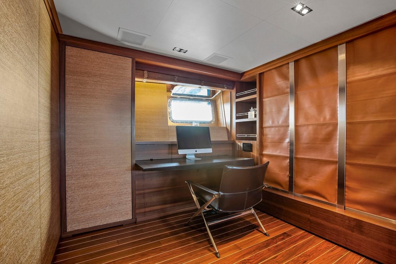 a room with a chair and a table aboard STATE OF GRACE Yacht for Sale