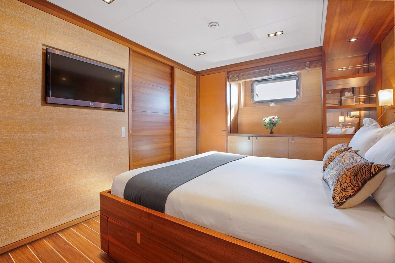 a bedroom with a bed and tv aboard STATE OF GRACE Yacht for Sale