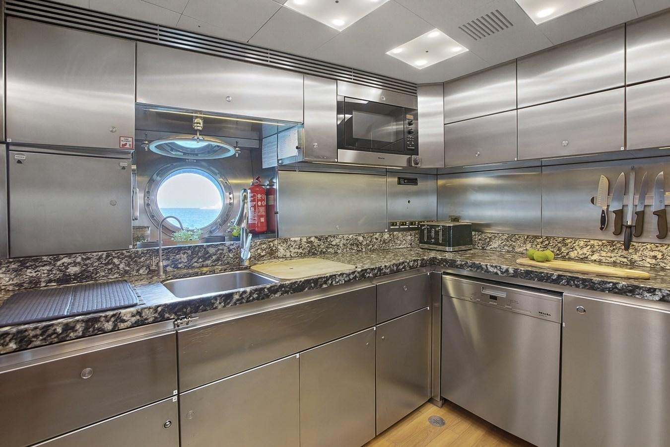 a large kitchen with stainless steel appliances aboard STATE OF GRACE Yacht for Sale