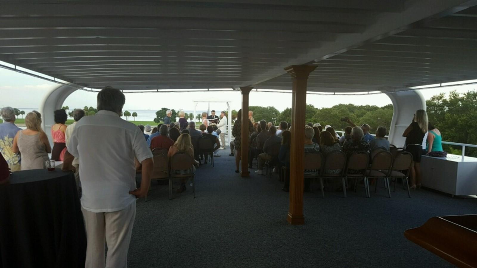 a person standing in a room with tables and chairs aboard SIR WINSTON Yacht for Sale