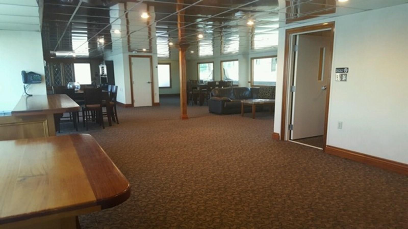 a room with tables and chairs aboard SIR WINSTON Yacht for Sale