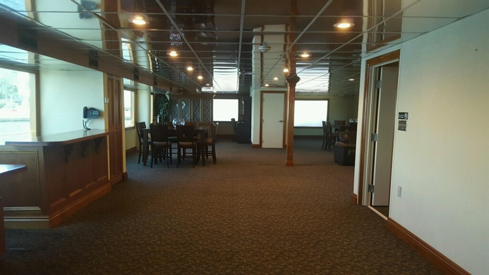 a room with chairs and tables aboard SIR WINSTON Yacht for Sale