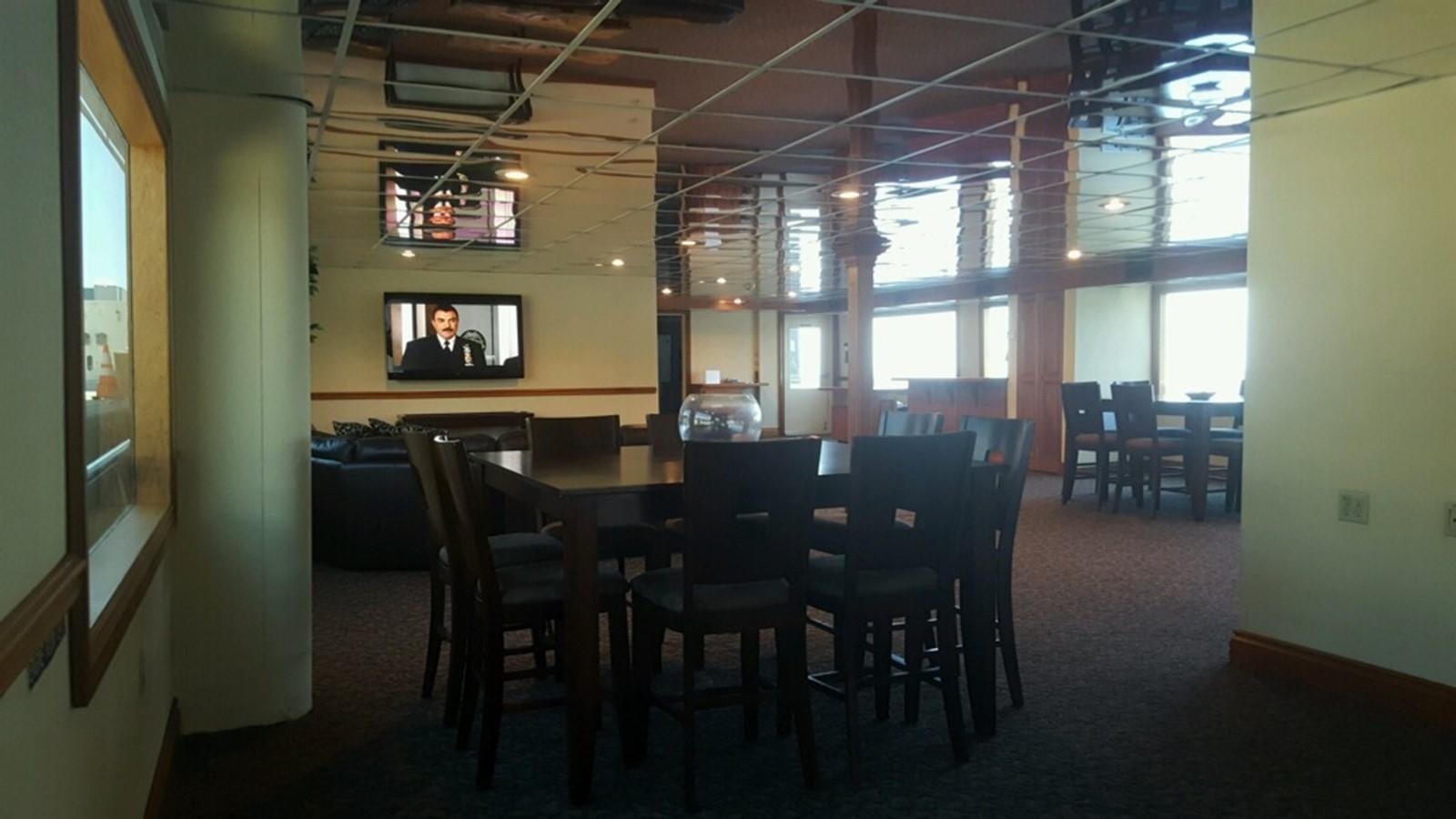 a room with a table and chairs aboard SIR WINSTON Yacht for Sale