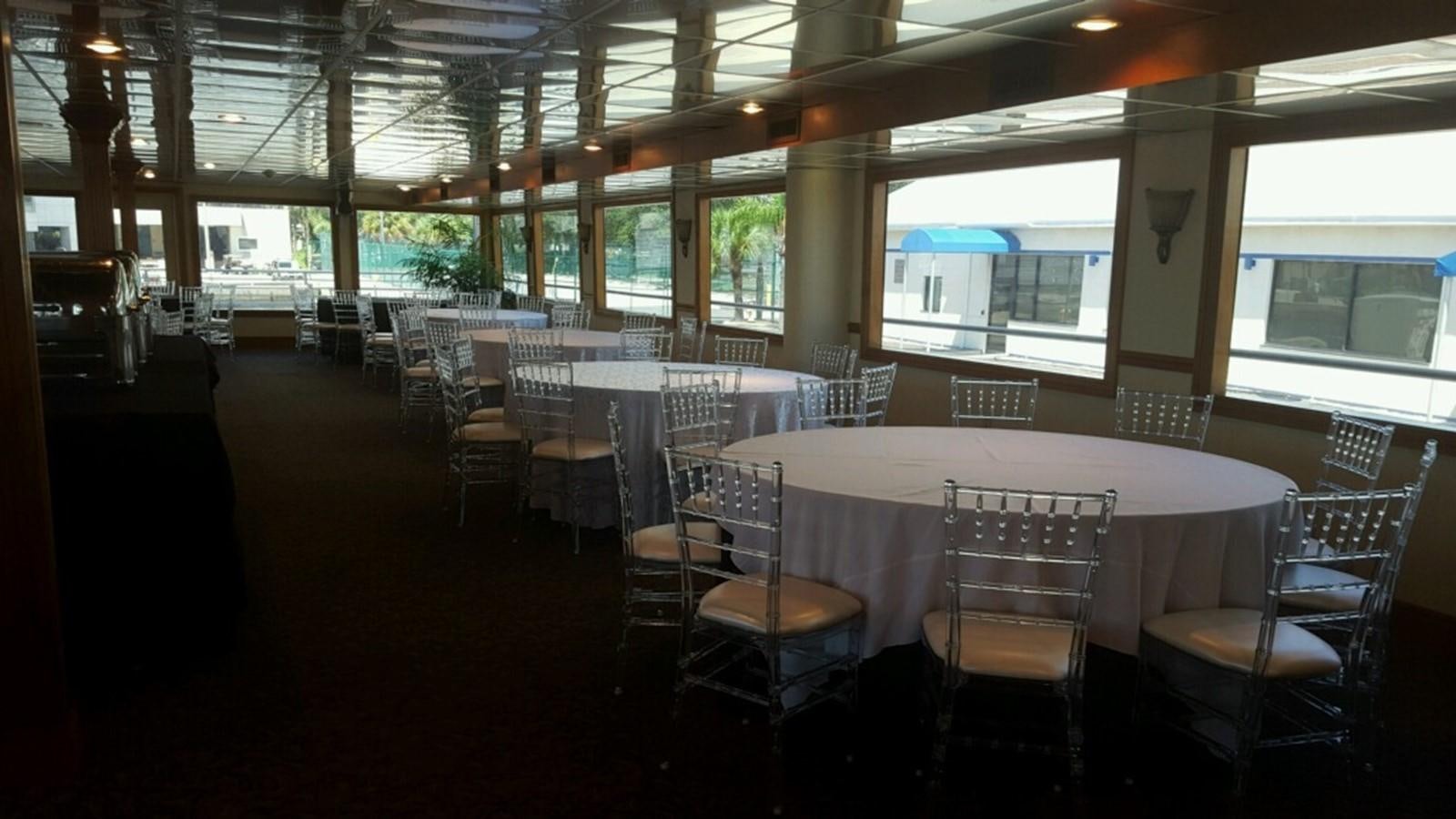 a room with tables and chairs aboard SIR WINSTON Yacht for Sale