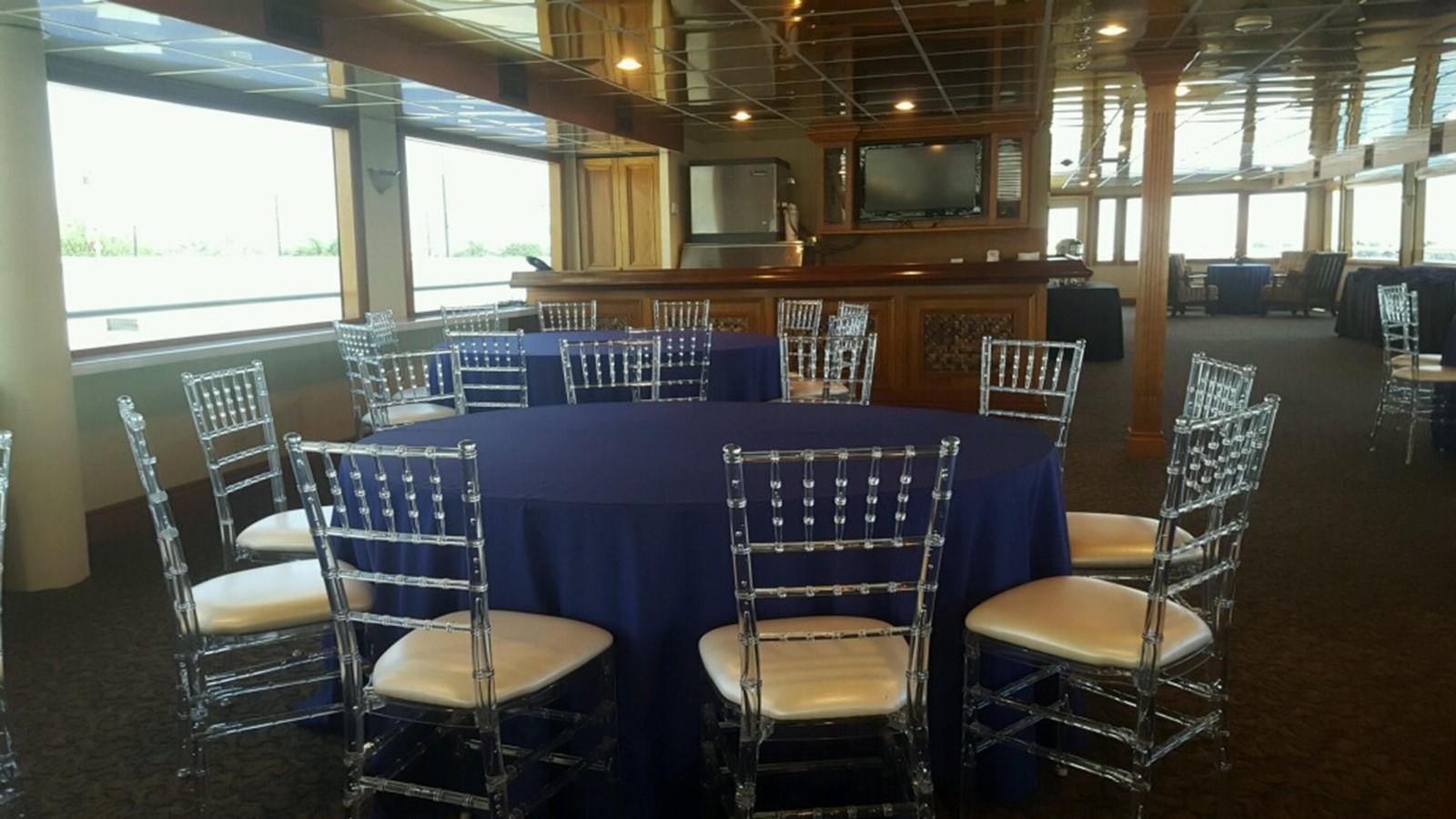 a room with tables and chairs aboard SIR WINSTON Yacht for Sale