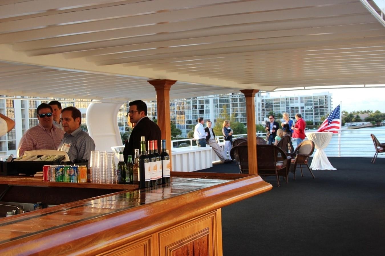 a group of people sitting at a bar aboard SIR WINSTON Yacht for Sale