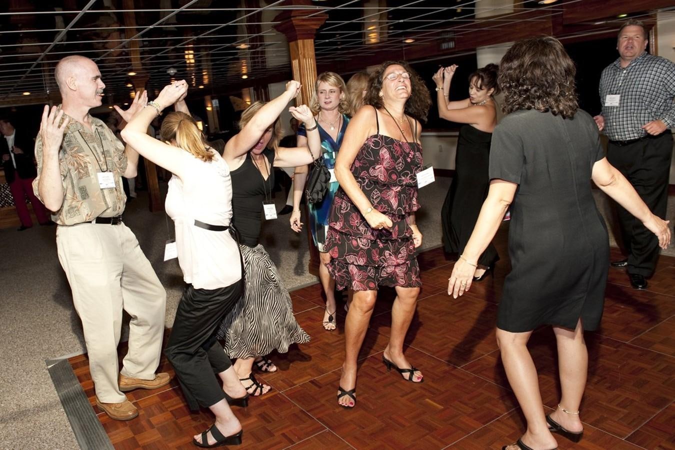 a group of people dancing aboard SIR WINSTON Yacht for Sale