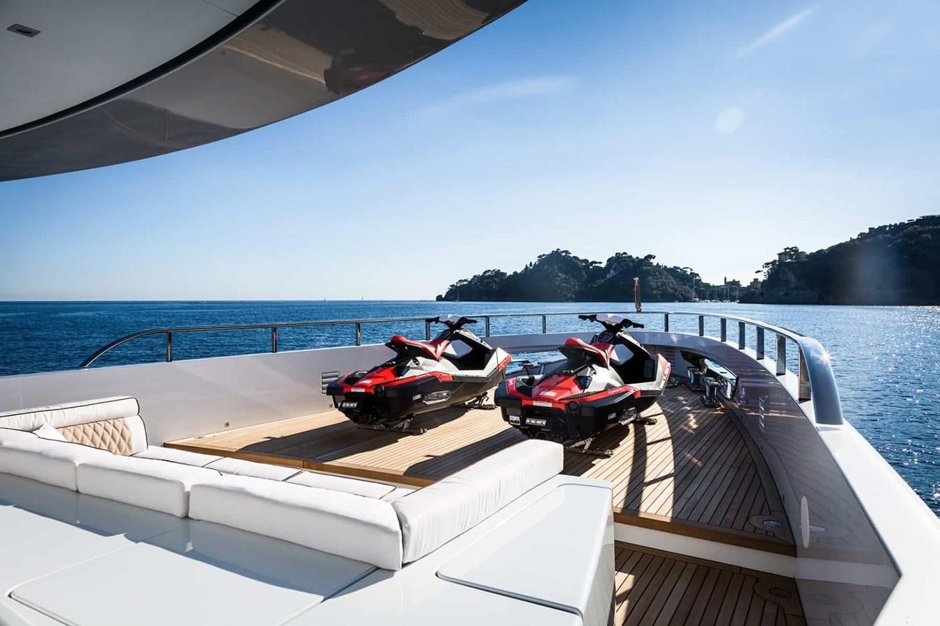a boat with a red car on it aboard GTT 130 Yacht for Sale