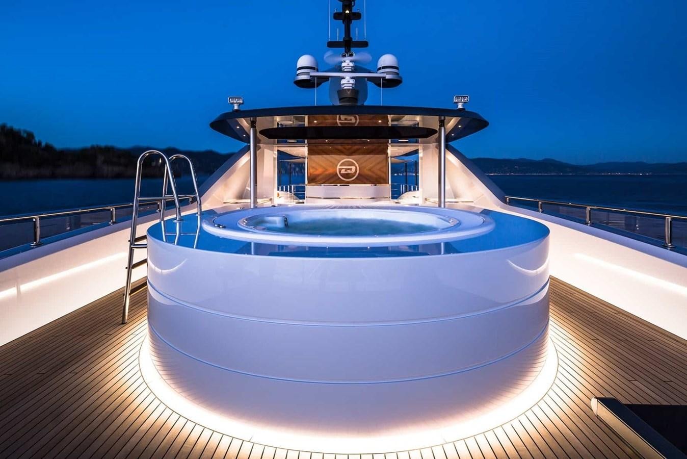 a large round swimming pool aboard GTT 130 Yacht for Sale
