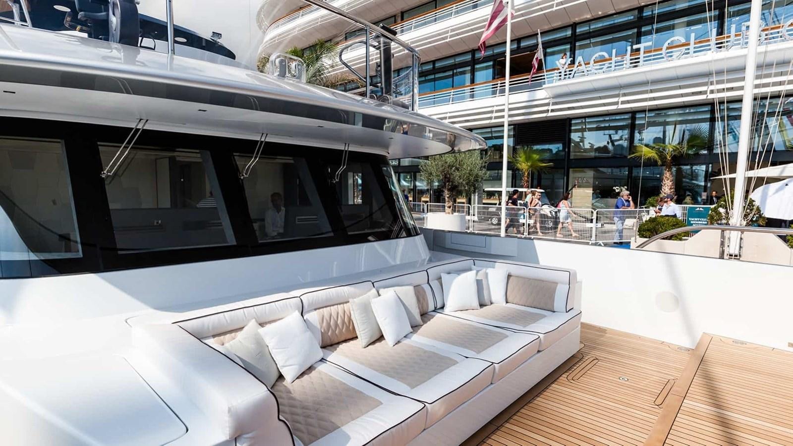 a large room with a large white couch and a large glass window aboard GTT 130 Yacht for Sale
