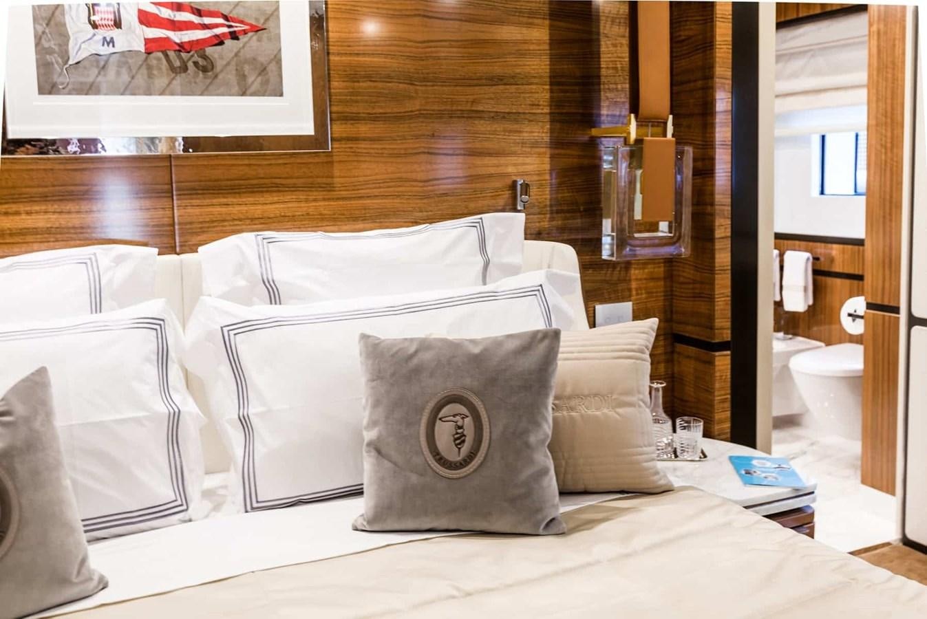 a bed with pillows on it aboard GTT 130 Yacht for Sale