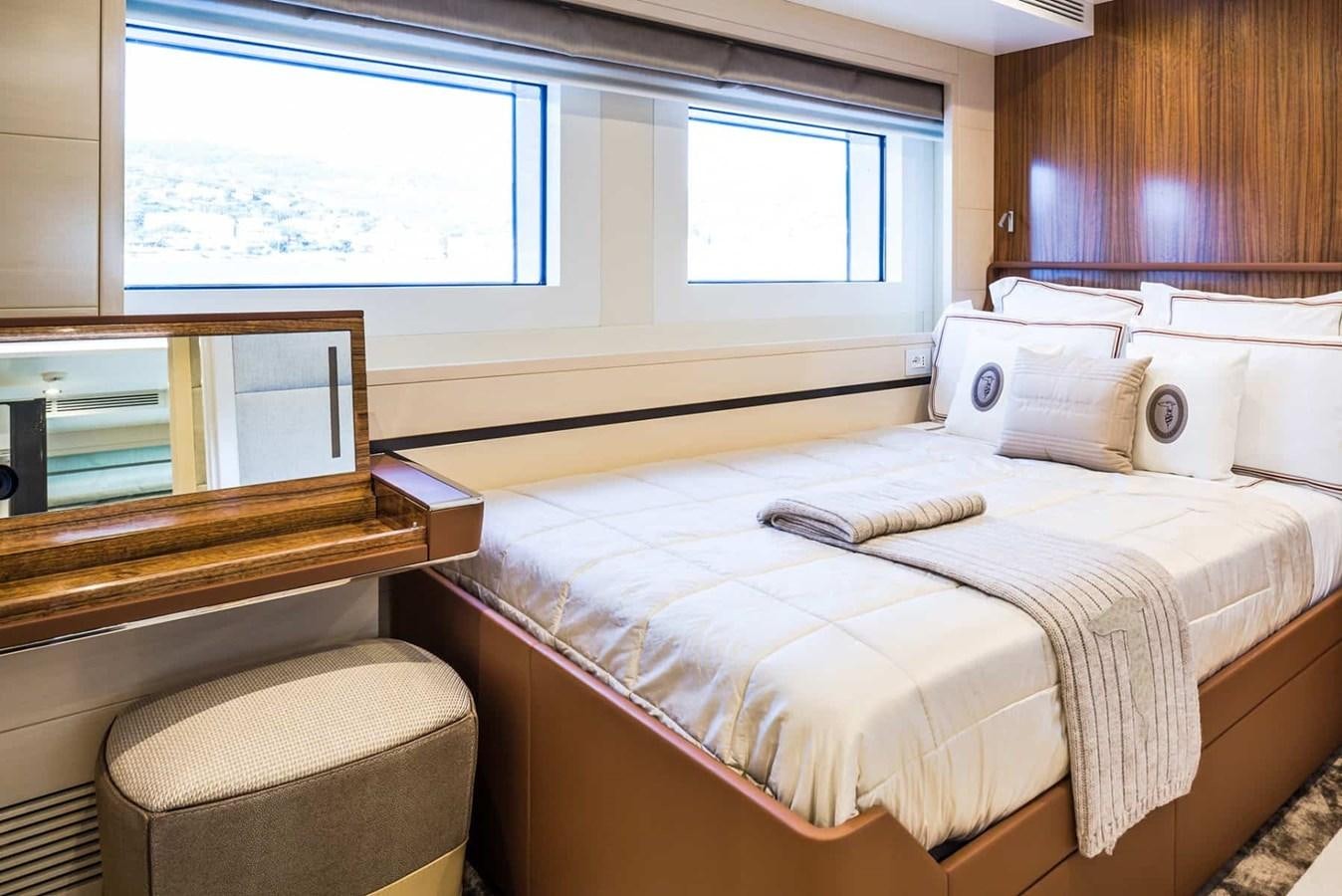a bed with a white bed spread aboard GTT 130 Yacht for Sale
