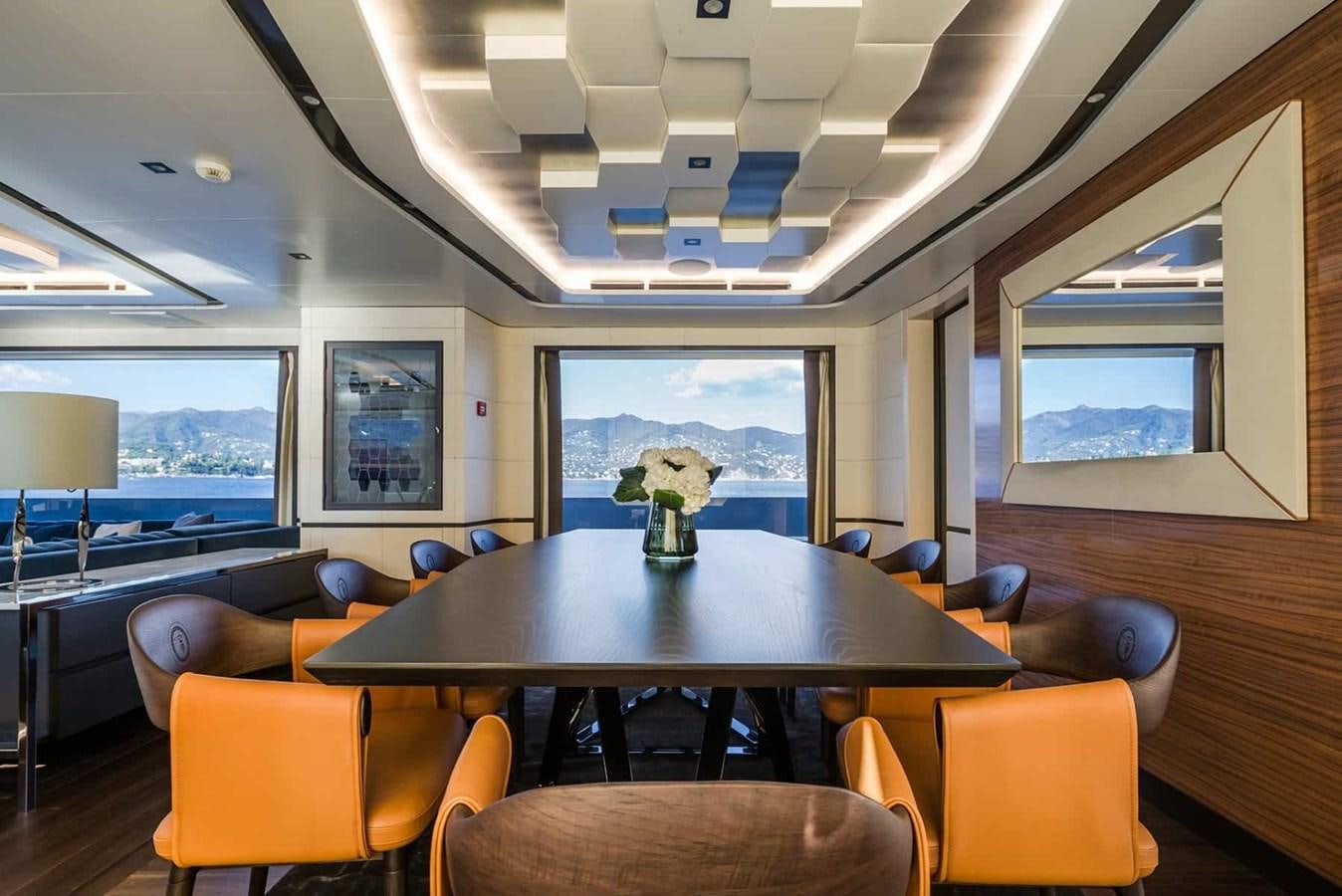 a room with a table and chairs aboard GTT 130 Yacht for Sale