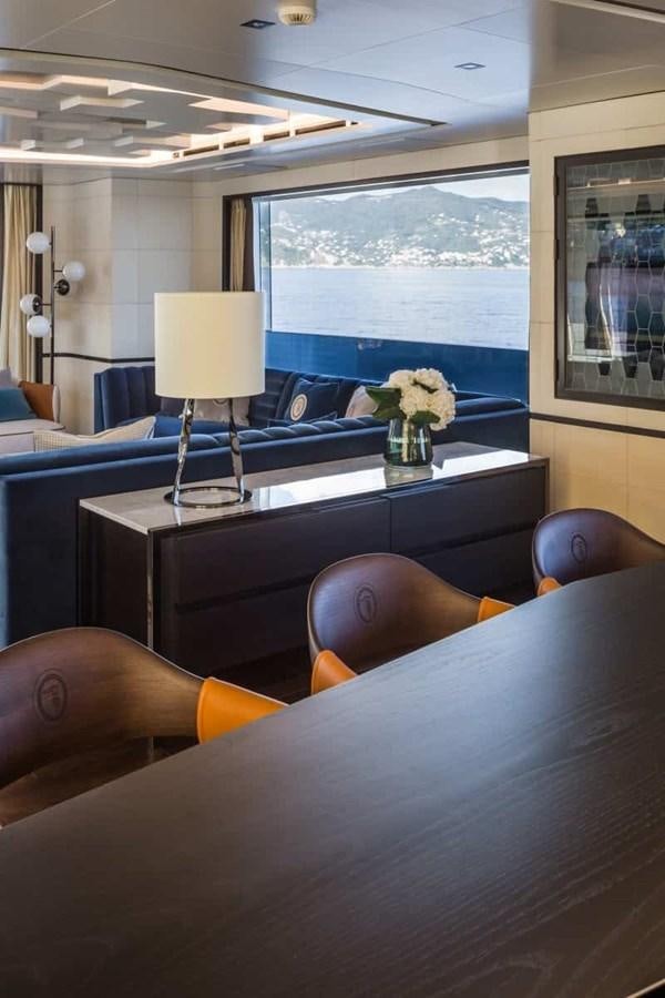 a room with a table and chairs aboard GTT 130 Yacht for Sale