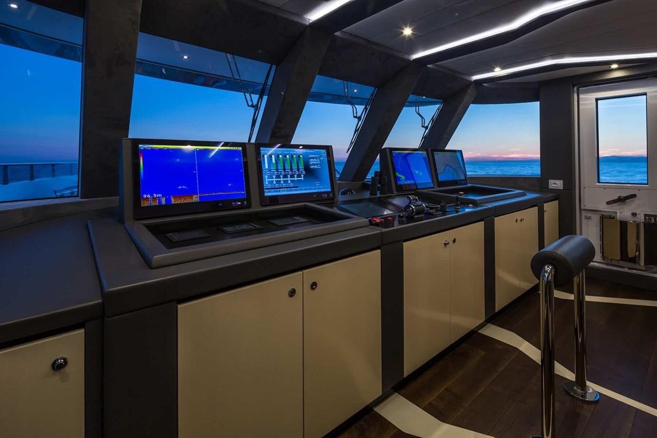 a row of computers on a desk aboard GTT 130 Yacht for Sale