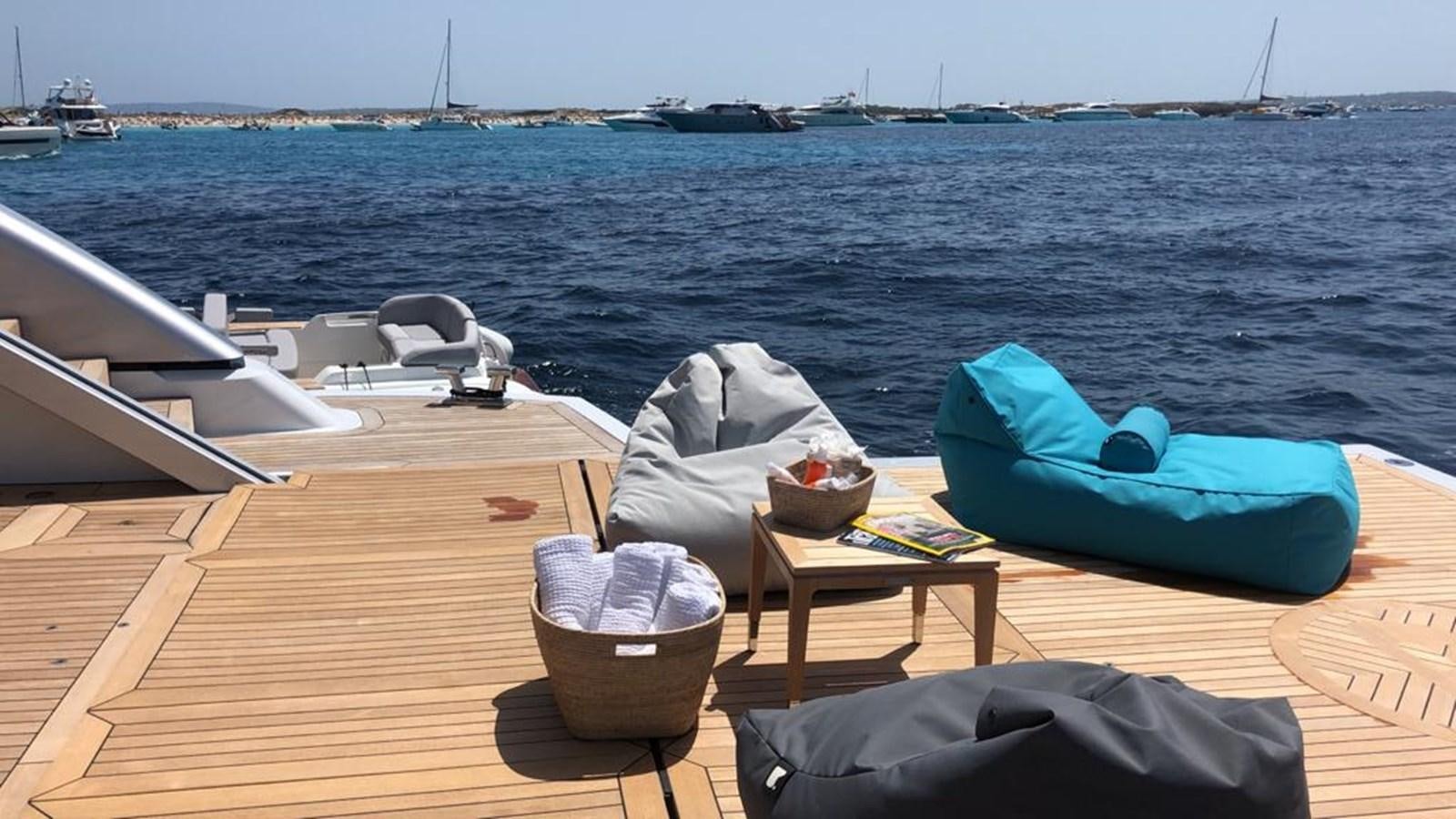 a picnic table on a deck overlooking the ocean aboard GTT 130 Yacht for Sale