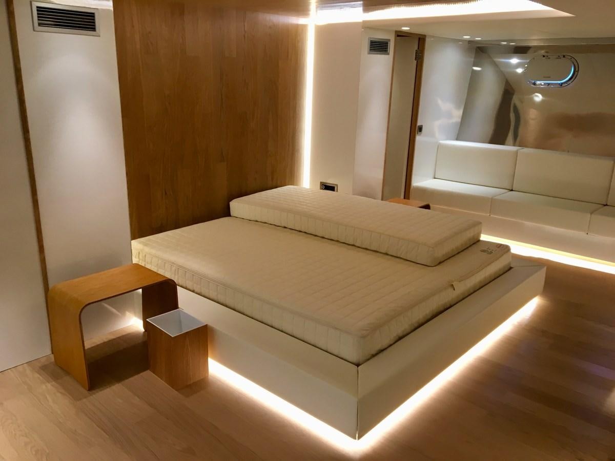 a room with a bed and a table aboard SHAMEKH Yacht for Sale