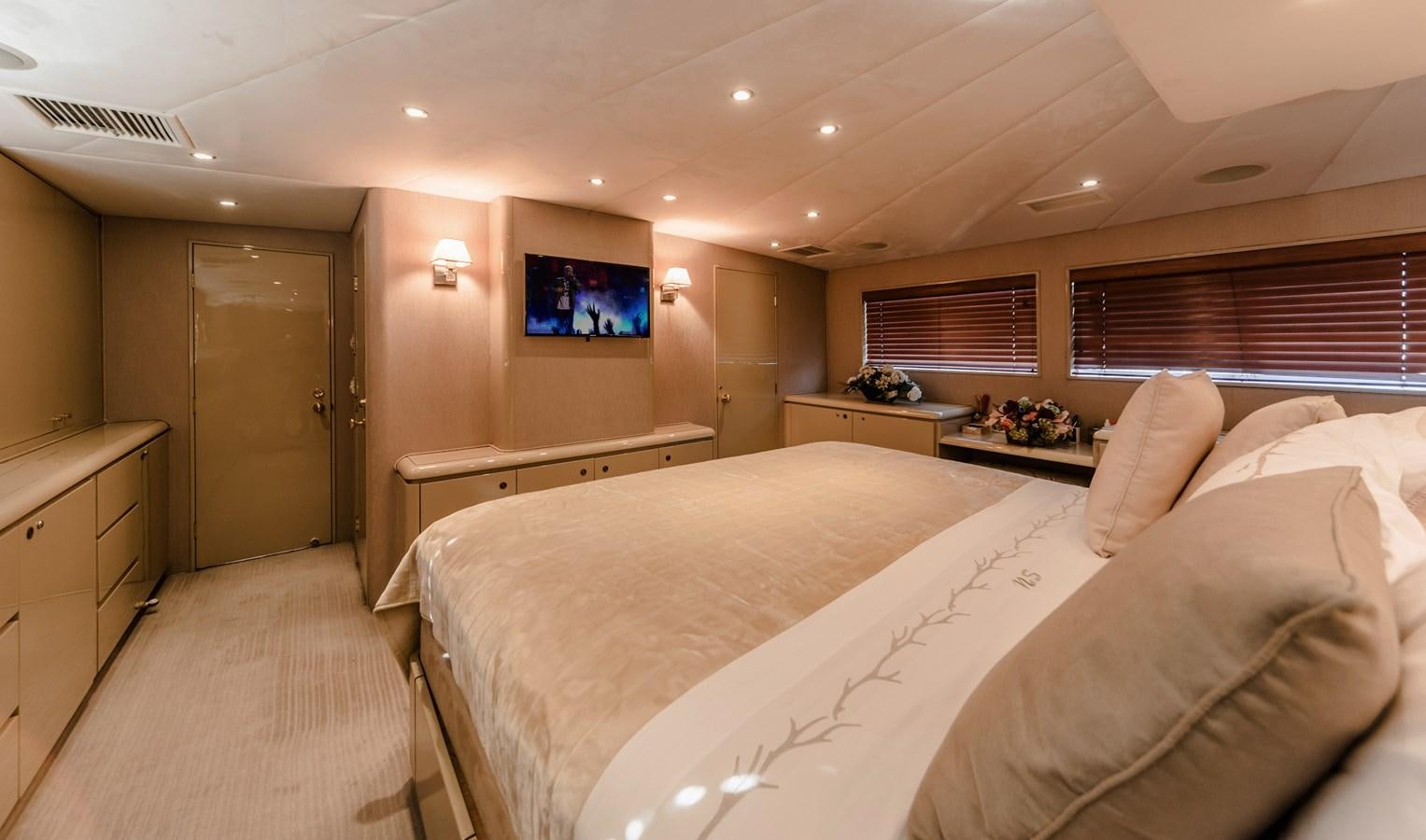 a bedroom with a bed and a tv on the wall aboard SU Yacht for Sale