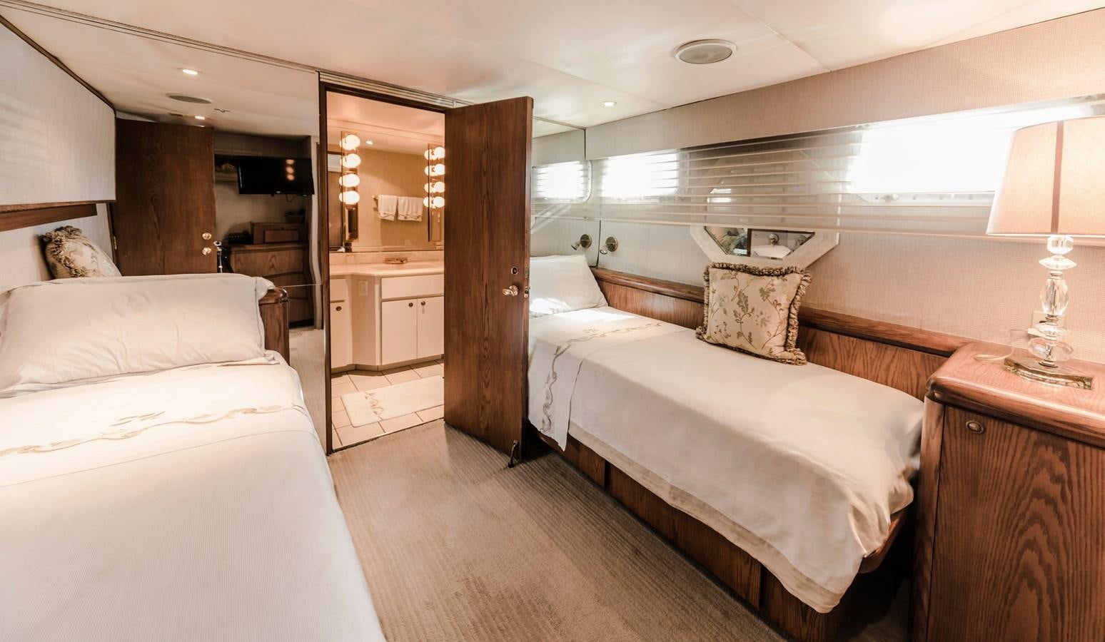 a room with a bed and a mirror aboard SU Yacht for Sale