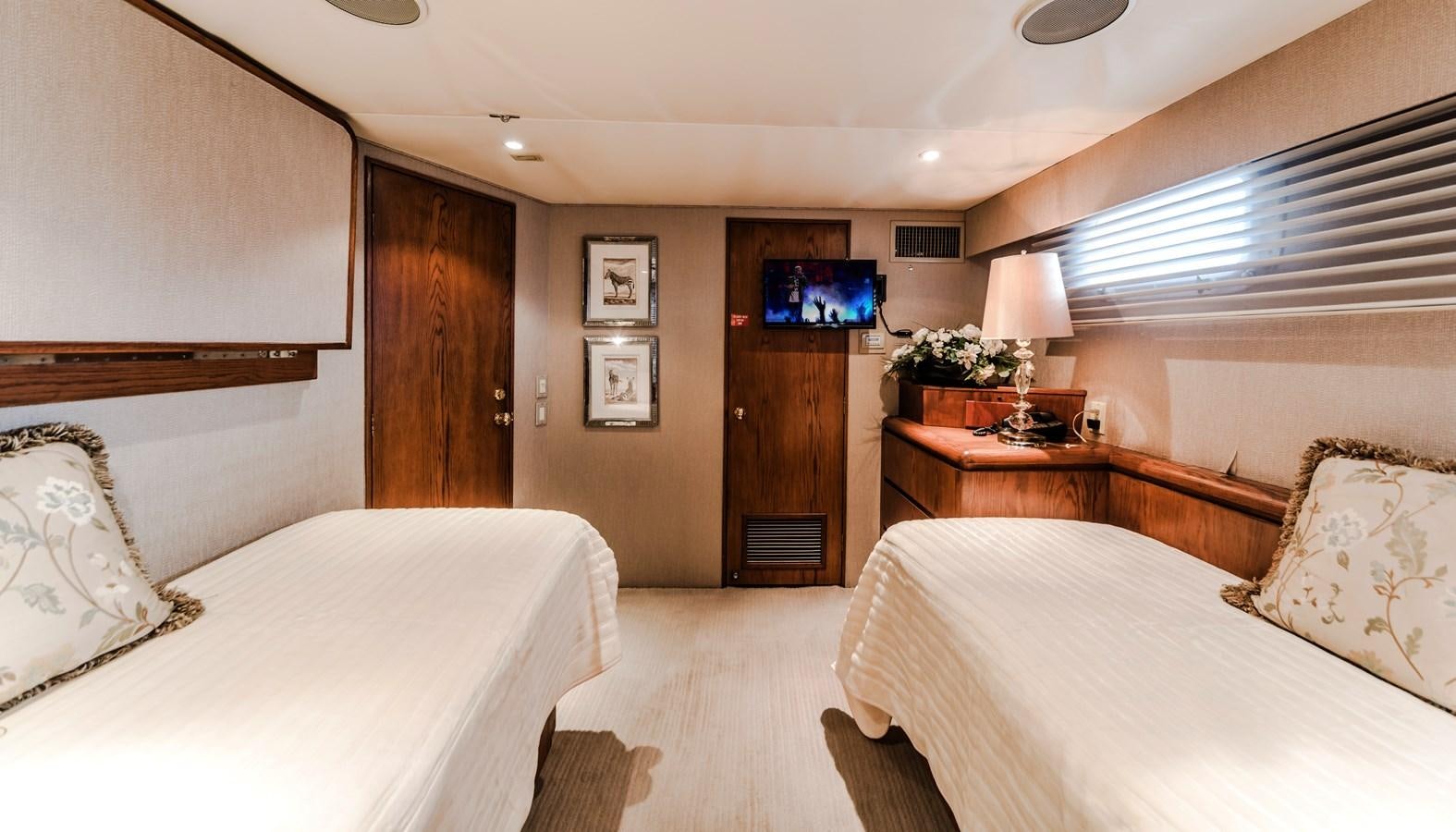 a room with a bed and a television aboard SU Yacht for Sale
