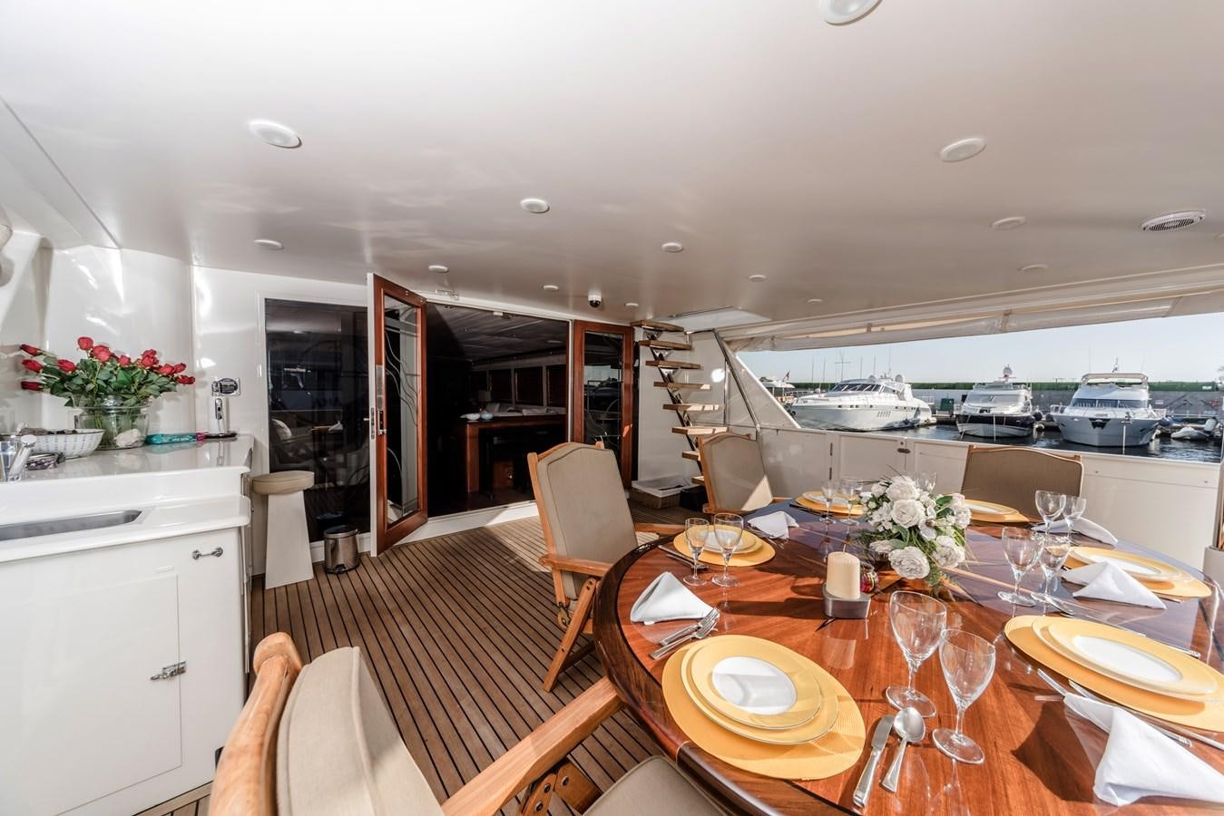 a dining table with chairs and a view of the water aboard SU Yacht for Sale