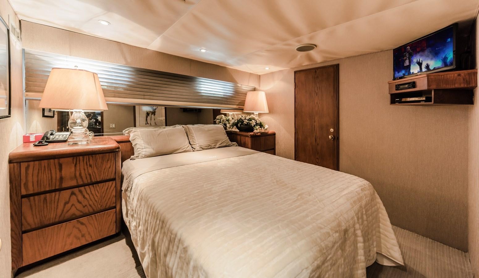 a bedroom with a bed and a television aboard SU Yacht for Sale