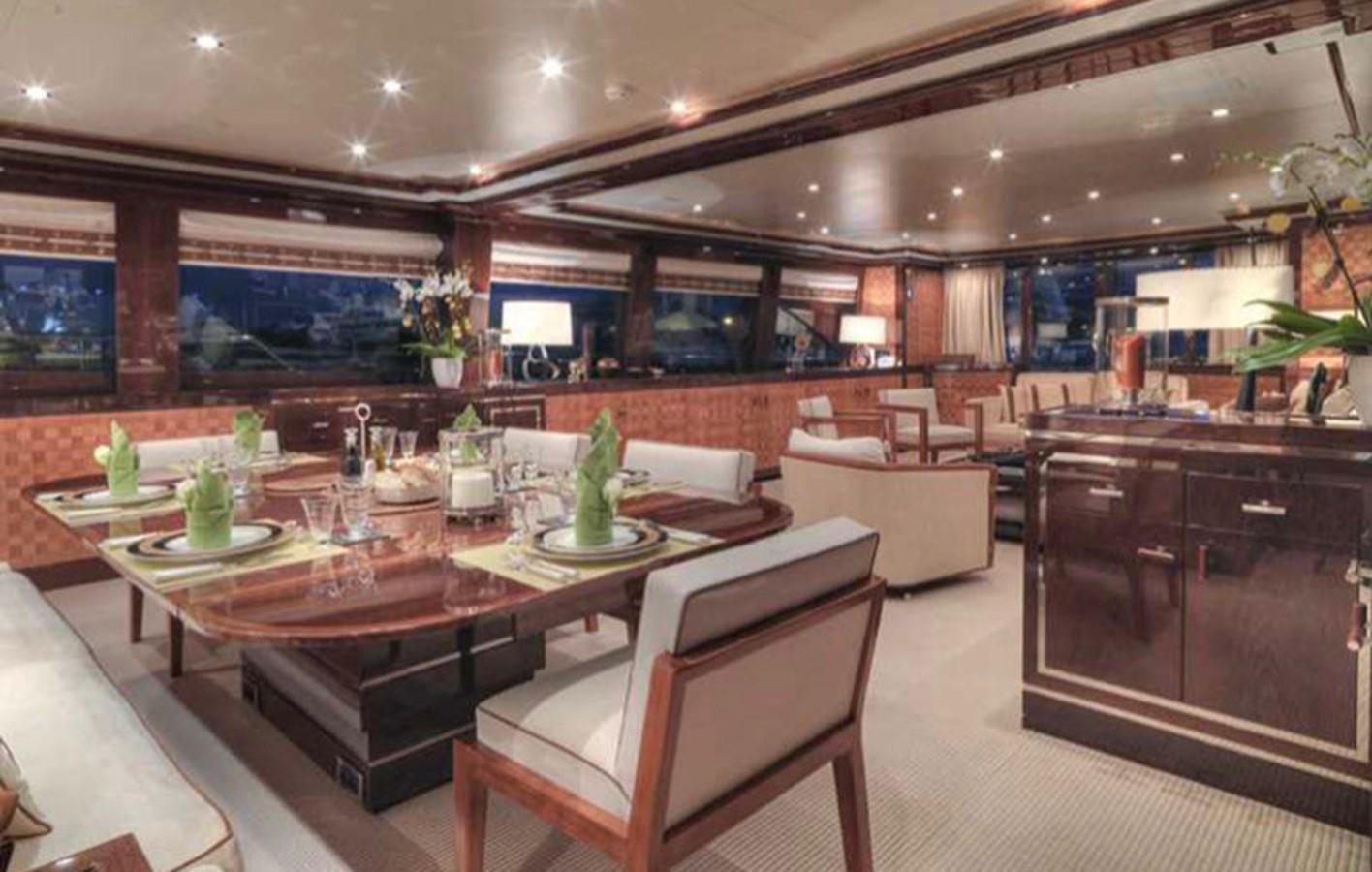 a large room with a table and chairs aboard COUACH 120 Yacht for Sale