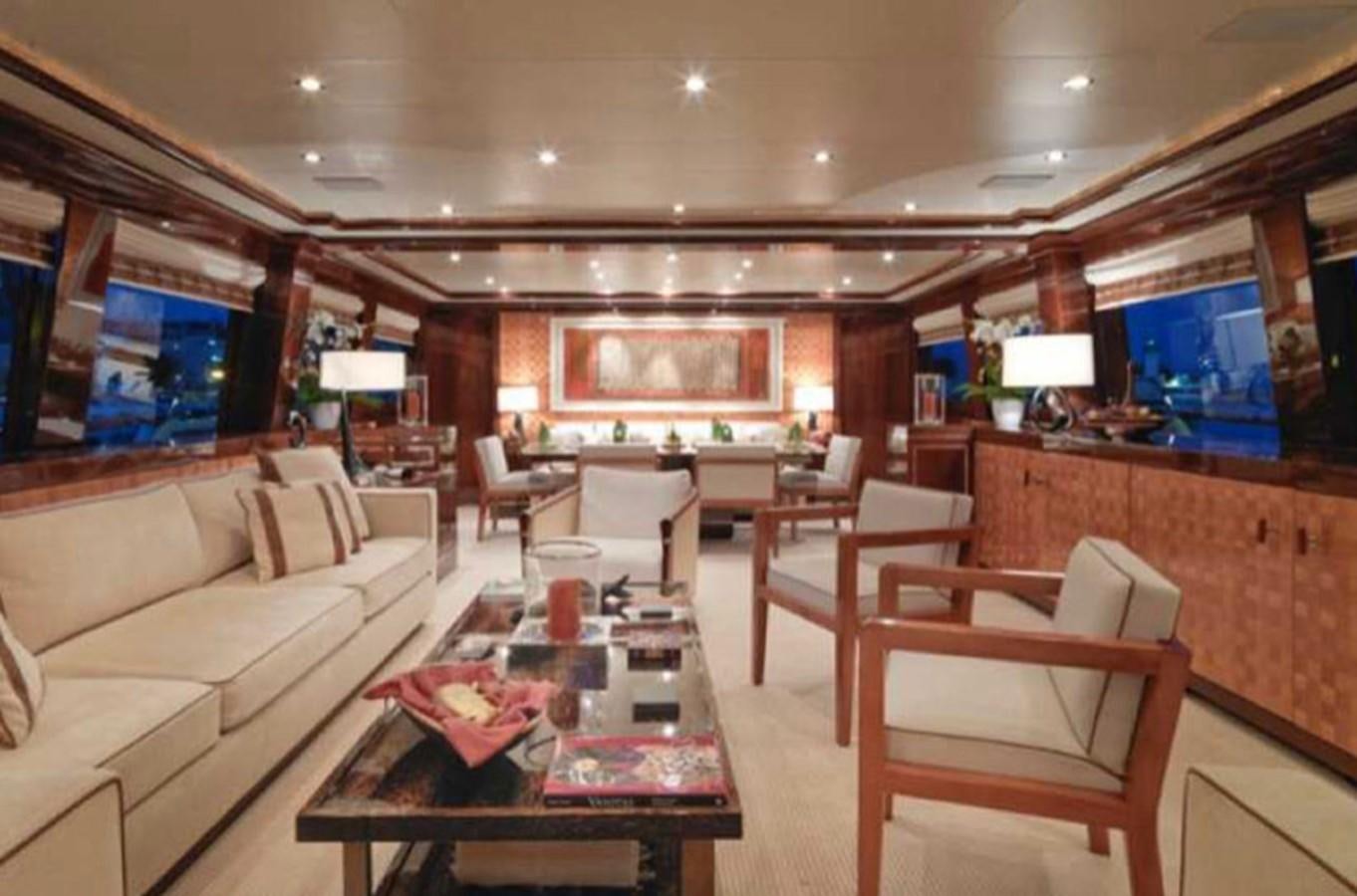 a living room with a large screen aboard COUACH 120 Yacht for Sale