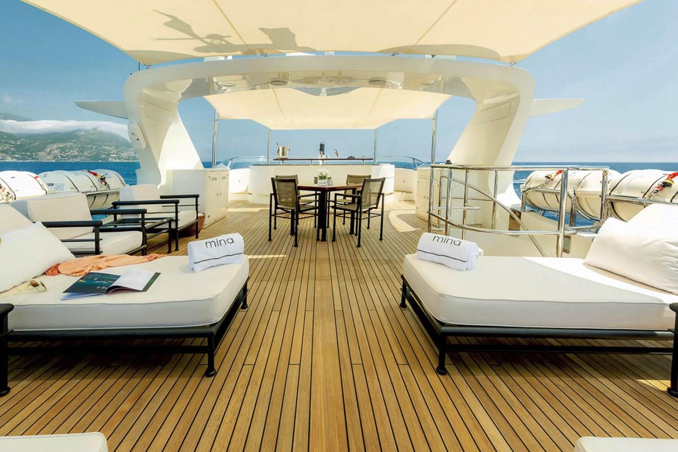 a room with a bed and a table and chairs aboard MINA Yacht for Sale