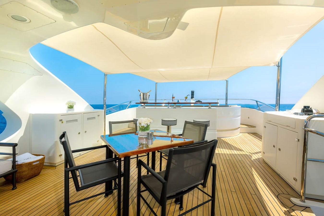 a dining table and chairs on a boat aboard MINA Yacht for Sale