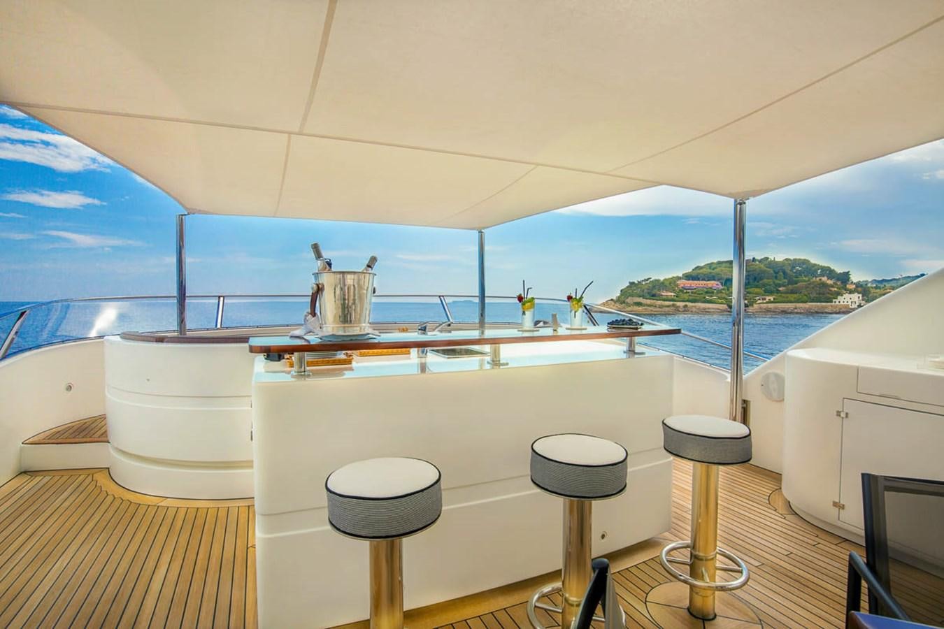 a table with stools on it aboard MINA Yacht for Sale